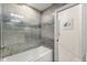 Updated bathroom featuring gray marbled tile shower and a white soaking tub at 205 Torcaso Ct, Winter Springs, FL 32708