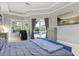 A large main bedroom with tiled floors, gray walls, and a view of the backyard pool at 205 Torcaso Ct, Winter Springs, FL 32708
