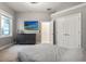 Bedroom with a large window, dresser with mounted TV, and access to the ensuite bathroom and walk-in closet at 205 Torcaso Ct, Winter Springs, FL 32708