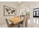 Bright dining room with tile floors, chandelier, and access to the foyer at 205 Torcaso Ct, Winter Springs, FL 32708
