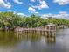 Waterfront wooden dock with gazebo and beautiful views of the surrounding landscape at 205 Torcaso Ct, Winter Springs, FL 32708