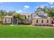 Beautiful two-story home with a well-manicured lawn, red mulch, and mature trees at 205 Torcaso Ct, Winter Springs, FL 32708