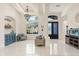 Grand foyer featuring tile floors, chandelier, aquarium, and front doors at 205 Torcaso Ct, Winter Springs, FL 32708