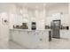 A modern kitchen featuring white cabinetry, stainless steel appliances, and tiled floors at 205 Torcaso Ct, Winter Springs, FL 32708