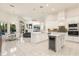 An open kitchen showcasing white cabinets, stainless steel appliances, and an attached dining area at 205 Torcaso Ct, Winter Springs, FL 32708