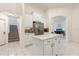 A well-lit kitchen with a marble island, white cabinets, and stainless steel appliances at 205 Torcaso Ct, Winter Springs, FL 32708