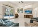 A comfortable living room with tile floors, a large TV, and a view of the pool at 205 Torcaso Ct, Winter Springs, FL 32708