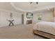 Spacious main bedroom with tray ceiling, a wall mounted television, and a sitting area, and ensuite bathroom at 205 Torcaso Ct, Winter Springs, FL 32708
