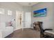 Cozy office space with a comfortable chair, a television for entertainment, and shelving for storage and decoration at 205 Torcaso Ct, Winter Springs, FL 32708