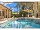 Screened in pool area with a clear blue swimming pool, lounge chairs, a seating area, and lush landscaping around the perimeter at 205 Torcaso Ct, Winter Springs, FL 32708