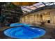 Screened pool area with a pool and jacuzzi, lounge chairs, and outdoor entertaining space, all with covered screening at 205 Torcaso Ct, Winter Springs, FL 32708