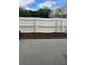 This backyard is enclosed with a white fence, patio, and small flower bed at 247 Debora Ct # 1, Altamonte Springs, FL 32701