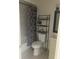 Compact bathroom featuring a shower-tub combo, modern fixtures, and storage shelving at 247 Debora Ct # 1, Altamonte Springs, FL 32701