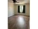 Cozy bedroom with wood-look flooring and a window providing natural light at 247 Debora Ct # 1, Altamonte Springs, FL 32701