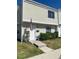 Charming two-story townhome with cream siding, an American flag, and well-maintained landscaping at 247 Debora Ct # 1, Altamonte Springs, FL 32701