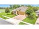 Lovely house features a brick driveway, an attached two-car garage, and a well-maintained lawn in a quiet neighborhood at 2724 Westyn Cove Ln, Ocoee, FL 34761