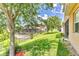 Backyard view of covered and screened in patio and lush, well-manicured lawn at 2724 Westyn Cove Ln, Ocoee, FL 34761