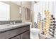 Bathroom with granite countertops and shower-tub with patterned shower curtain at 2724 Westyn Cove Ln, Ocoee, FL 34761