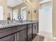 Bathroom featuring double sink vanity with granite countertops and a tiled shower at 2724 Westyn Cove Ln, Ocoee, FL 34761