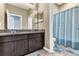 Bathroom with double sink vanity, tiled floor, and shower with patterned curtain at 2724 Westyn Cove Ln, Ocoee, FL 34761