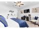 Bedroom with white walls, ceiling fan, mounted TV and furniture at 2724 Westyn Cove Ln, Ocoee, FL 34761