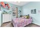 Bedroom featuring a window and light blue walls adorned with various decorations at 2724 Westyn Cove Ln, Ocoee, FL 34761