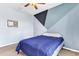 Bedroom with geometrically painted blue walls, carpeted floor, and ceiling fan at 2724 Westyn Cove Ln, Ocoee, FL 34761