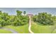 Tranquil view of a dock with a gazebo, surrounded by lush greenery and overlooking a serene body of water at 2724 Westyn Cove Ln, Ocoee, FL 34761