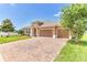 Lovely home with brick driveway, well-maintained lawn, and two-car garage on a sunny day at 2724 Westyn Cove Ln, Ocoee, FL 34761