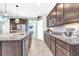 Gourmet kitchen boasts granite counters, stainless appliances, ample cabinetry, and an island with seating at 2724 Westyn Cove Ln, Ocoee, FL 34761
