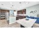 Open kitchen with granite counters, dark wood cabinets, stainless appliances and an island with bar seating at 2724 Westyn Cove Ln, Ocoee, FL 34761