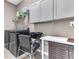 Laundry room with washer, dryer, utility sink and gray overhead cabinets at 2724 Westyn Cove Ln, Ocoee, FL 34761
