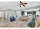 Cozy living room features tile floors and an open layout to the kitchen and a ceiling fan at 2724 Westyn Cove Ln, Ocoee, FL 34761