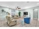 Living room with tiled floors, neutral colored sofas, ceiling fan, and large TV at 2724 Westyn Cove Ln, Ocoee, FL 34761