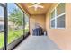 Screened-in patio with ceiling fan and a grill; an outdoor living space at 2724 Westyn Cove Ln, Ocoee, FL 34761