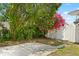 Charming backyard with lush greenery, fencing, and shaded patio area at 2906 E Grant Ave, Orlando, FL 32806