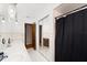 Well-lit bathroom featuring a long vanity and separate shower space with a black curtain at 2906 E Grant Ave, Orlando, FL 32806