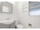 Bright bathroom featuring a sink with storage, a toilet, and shelving at 2906 E Grant Ave, Orlando, FL 32806