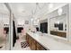 Bathroom featuring double mirrors over a long vanity and retro light fixtures at 2906 E Grant Ave, Orlando, FL 32806