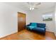Neutral bedroom with wood floors, closet, sofa, and natural light from the window at 2906 E Grant Ave, Orlando, FL 32806