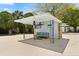Outdoor cabana with a tv, comfortable seating, lighting, bar area, and backyard views for entertaining at 2906 E Grant Ave, Orlando, FL 32806