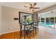 Cozy dining room features a modern table set, ceiling fan, and view of the bright pool area at 2906 E Grant Ave, Orlando, FL 32806
