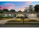 Charming single-story home with a well-manicured front yard and attached garage at 2906 E Grant Ave, Orlando, FL 32806