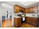 Kitchen featuring wood cabinets, stainless steel appliances, and an open doorway to the next room at 2906 E Grant Ave, Orlando, FL 32806