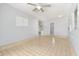 Open-concept living room with tile floor, ceiling fan, and kitchen view at 2906 E Grant Ave, Orlando, FL 32806