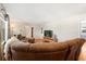 Spacious living room with hardwood floors, a sectional couch, and a TV at 2906 E Grant Ave, Orlando, FL 32806