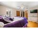 Cozy main bedroom with hardwood floors, a ceiling fan, and closet space at 2906 E Grant Ave, Orlando, FL 32806
