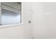 Shower with white tiled walls, showerhead, and window for natural light at 2906 E Grant Ave, Orlando, FL 32806