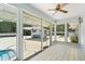 Bright sunroom with tile floors, large windows, and a view of the pool and outdoor living space at 2906 E Grant Ave, Orlando, FL 32806