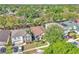 Aerial view showcasing the property's roof, manicured lawn, mature trees, and surrounding neighborhood at 300 Augustine Ct, Oviedo, FL 32765